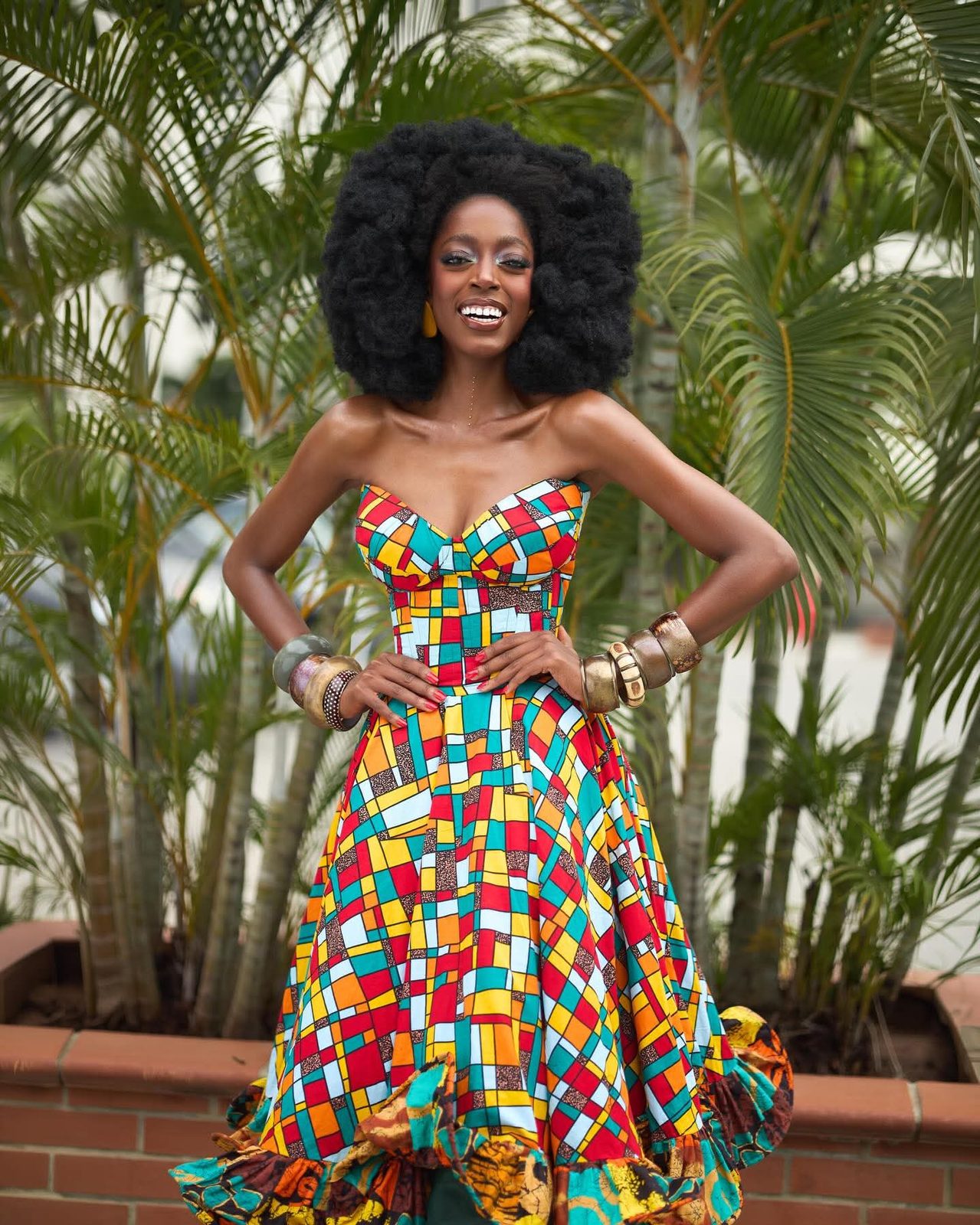 Yollanda Chimbarami smiling in a bright African print dress